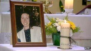 Photo of Catherine Gowing and candle inside funeral church