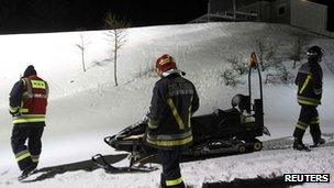 Rescue workers take part in an operation to recover bodies of tourists in Val di Fiemme, northern Italy.