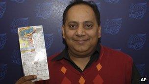 This undated photo provided by the Illinois Lottery shows Urooj Khan posing with a winning lottery ticket