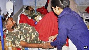 Indian Central Reserve Police Force soldiers, in uniform, are treated at a hospital in Daltangunj, Jharkhand, India, Monday, Jan. 7, 2013.