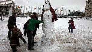 Children in Ramallah, West Bank, make a snowman. 10 Jan 2013