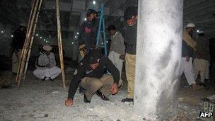 Police inspect the site of an explosion in north-west Pakistan
