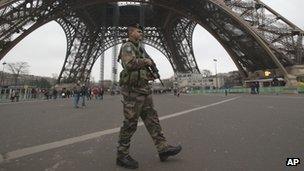 A French soldier patrols in front of the Eiffel Tower in Paris. Photo: 13 January 2013
