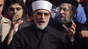 Muhammad Tahirul Qadri, leader of the Mihaj-ul-Quran movement, speaks before a protest march from Lahore to Islamabad