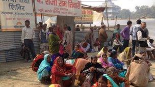 People sitting outside the lost and found camp at the Kumbh Mela
