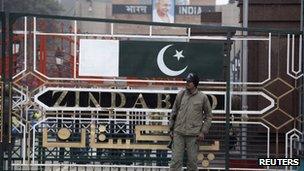 A paramilitary soldier stands guard beside a border gate at the India-Pakistan joint checkpoint at the Wagah border near Lahore 6 January 2013