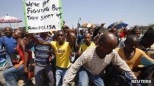 Striking platinum miners march near the Anglo-American Platinum mine near Rustenburg, South Africa, 5 October 2012