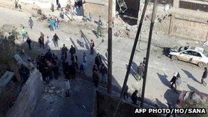 A Syrian State news agency-provided photo of officials inspecting bomb damage in Idlib