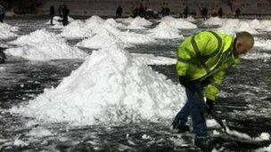 Man clearing snow on pitch