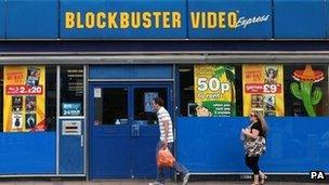 People walk past Blockbusters store (file photo 2010)