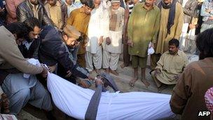 Pakistanis attend the funeral of Kamran Faisal