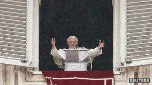 Pope Benedict XVI waves as he leads his Angelus prayer from the window of his private apartment in Saint Peter's Square at the Vatican.