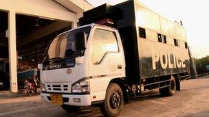 A Thai police van to take newly-arrived Rohingya away