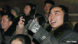 North Koreans take photos on mobile phones at New Year in Pyongyang (1 Jan 2013)
