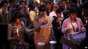 An Indian girl in the middle dressed as Lady Justice takes part in a candlelight vigil in Delhi for speedier trials in rape and sexual violence cases.