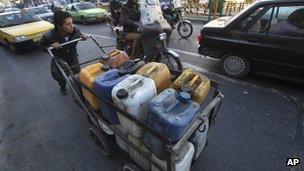 Iranian man pushing fuel containers in Tehran (23/01/13)
