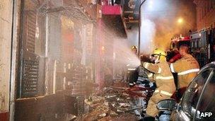 Firefighters try to put out a fire at the Kiss club in Santa Maria, Rio Grande do Sul, southern Brazil