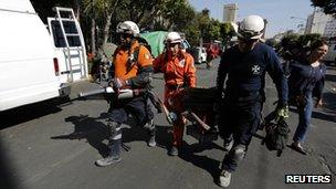 Rescue workers carrying equipment at the site of Thursday's blast in Mexico City