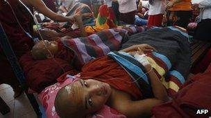 Burnt Buddhist monks receive treatment at a hospital after police reportedly fired water cannon and gas in Monywa, November 2012