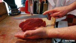 Horsemeat being prepared by a butcher in France