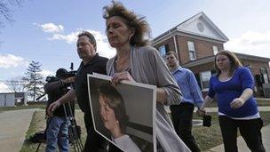 Kim Scruggs carries a picture of her son as she arrives for a hearing in Appottamox County, Virginia 15 February 2013