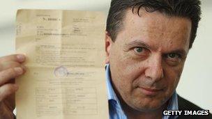 Nick Xenophon holds up his deportation order on return to Adelaide, 17 Feb