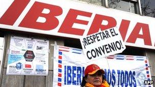 Workers demonstrate outside Iberia headquarters in Madrid