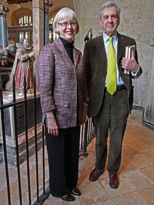 Dr Lesley Peterson and Lord Falkland, 15th Viscount Falkland in front of the effigy of Elizabeth Tanfield (Cary) on her parents' tomb in Burford Church