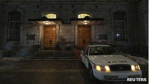 A Surete du Quebec police car sits outside the doors of Montreal City Hall during a raid by the province's anti-corruption squad in Montreal, 19 February 2013