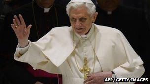 Pope Benedict XVI waves as he arrives for his weekly general audience at the Vatican on 13 February