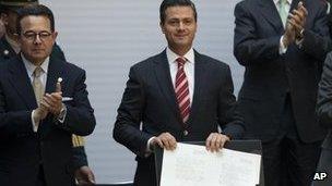 Mexico's president, Enrique Pena Nieto, shows signed education reform document