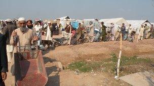 Internally displaced people in Jalozai camp queuing for rations