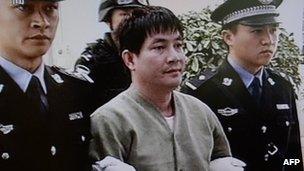 Convicted murderer Naw Kham is led from his cell in Yunnan, China (1 March 2013)
