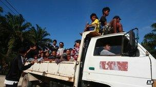 Residents leave their village in Tanjung Labian near Tanduo, where Malaysia launched airstrikes and mortar attacks against nearly 200 Filipinos occupying a Borneo coastal village on 5 March 2013