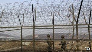 South Korean army soldiers patrol along a barbed-wire fence at the Imjingak Pavilion near the border village of Panmunjom, which has separated the two Koreas since the Korean War, in Paju, north of Seoul, South Korea, 6 March 2013