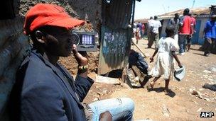 A man listens to a radio in Kenya on 5 March 2013