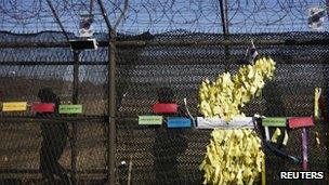 South Korean soldiers patrol past ribbons bearing peace messages arranged in the shape of the Korean peninsula near the demilitarized zone (DMZ) on 11 March 2013