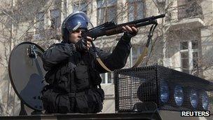 A policeman facing down protesters in Azerbaijan