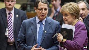 Cypriot President Nicos Anastasiades speaks to German Chancellor Angela Merkel at the EU summit in Brussels, 15 March
