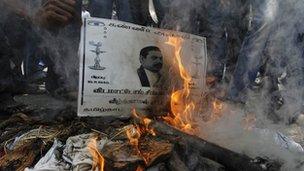 College students burn a poster of Sri Lanka"s President Mahinda Rajapaksa during a protest in the southern Indian city of Chennai March 21, 2013