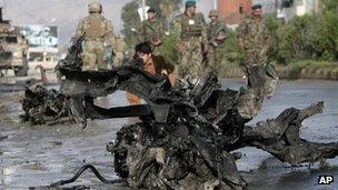 Afghan police and U.S. forces arrive to the scene after eight suicide bombers attacked a police headquarters in the eastern Afghan city of Jalalabad, Afghanistan, Tuesday, March 26, 2013
