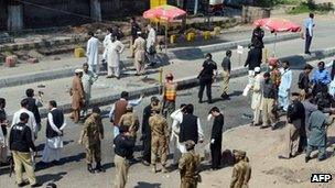 Pakistani soldiers gather at the site of a suicide attack in Peshawar on March 29, 2013.