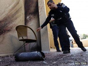 Near Sderot in Israel - 3 April. Collecting the remains of a rocket