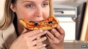 woman eating pizza
