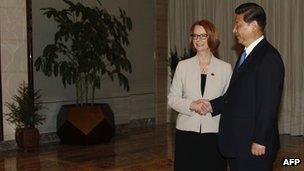 China's President Xi Jinping shakes hands with Australia's Prime Minister Julia Gillard