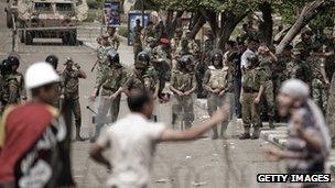 Egyptian anti-military protesters confront army troops during a protest outside the defence ministry on May 4, 2012