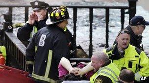 First responders care for an injured person at the Boston Marathon
