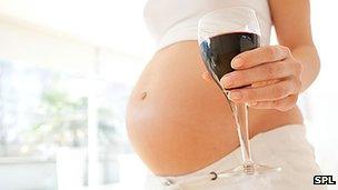 Pregnant bump and wine glass