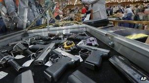 file photo of handguns on display at the table of David Petronis of Mechanicville, New York 26 January 2013