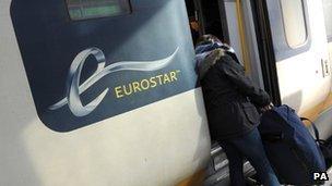 Passenger loading her bag onto a Eurostar train